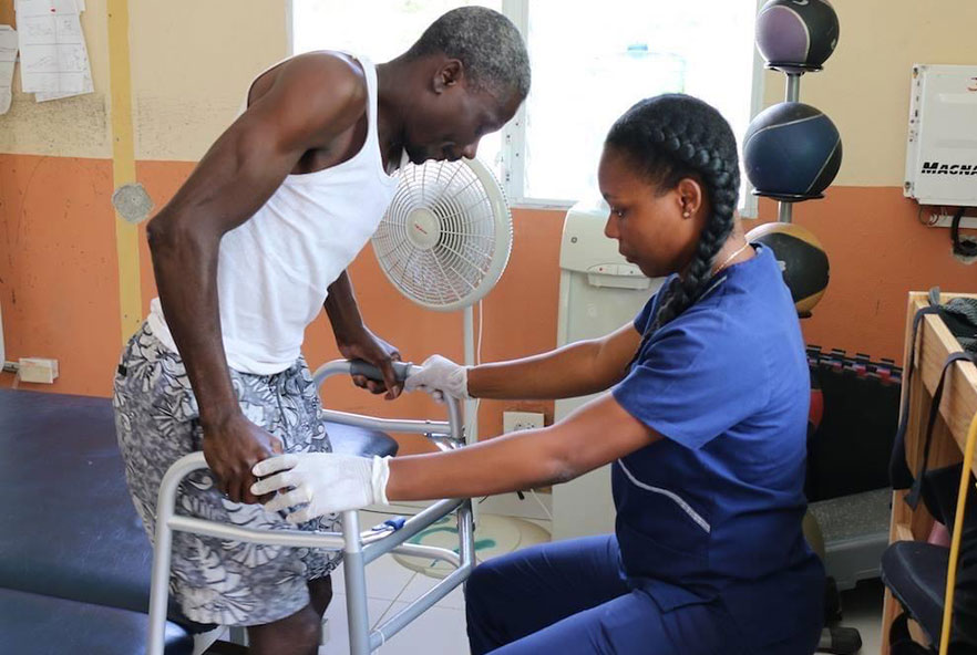 A physiotherapist helps a patient