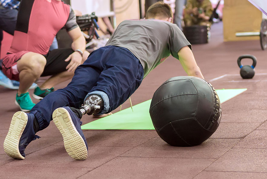 A man with a prosthetic leg doing a push up