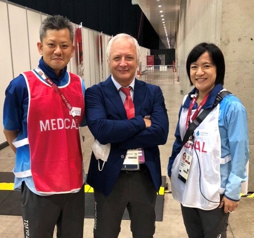 Japanese physiotherapist Takayuki Suzuki, left, with Antonio Fiore, centre, and athlete medical supervisor Anna Tomori, right