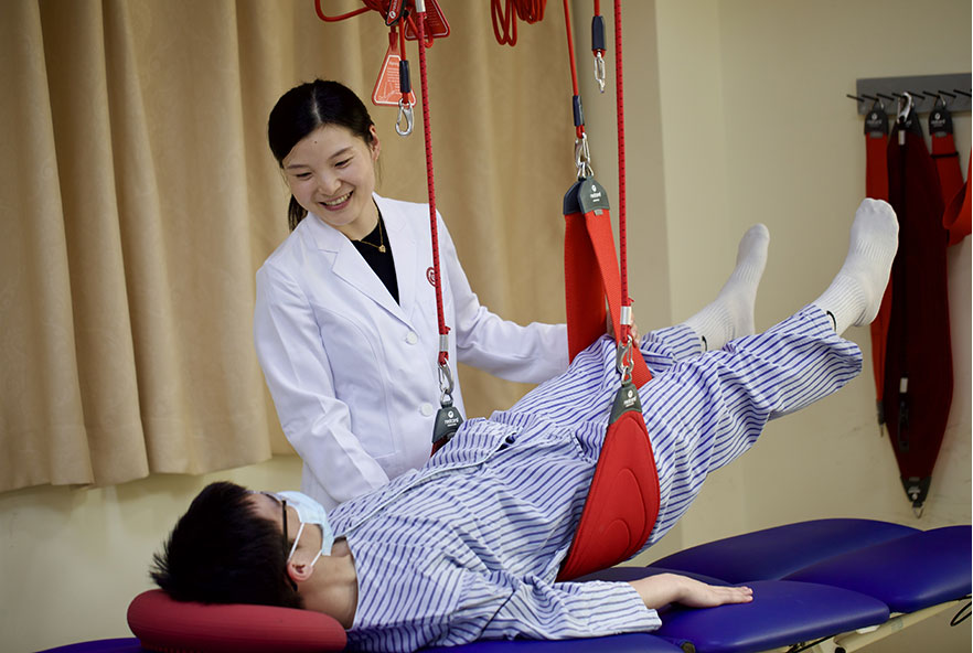 Photo of a physiotherapist working with a child patient in China