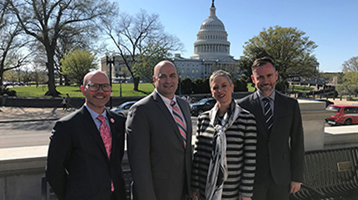 Emilio Rouco, Justin Elliott, Emma Stokes and Jonathon Kruger stand in front of Capitol Hill