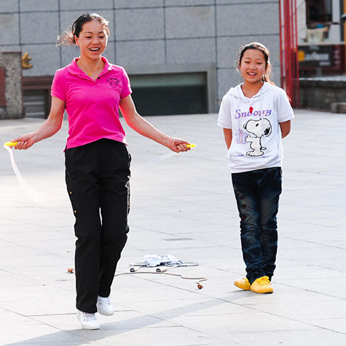 A photo of a young woman skipping