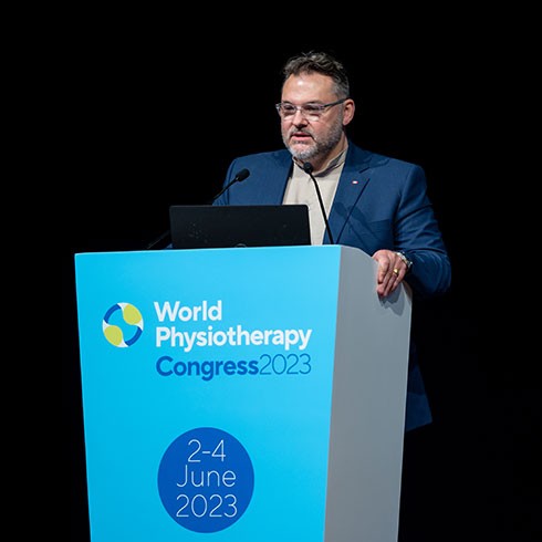 Photo of Mike Landry speaking at a World Physiotherapy congress