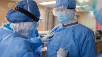 Two physiotherapists wearing PPE