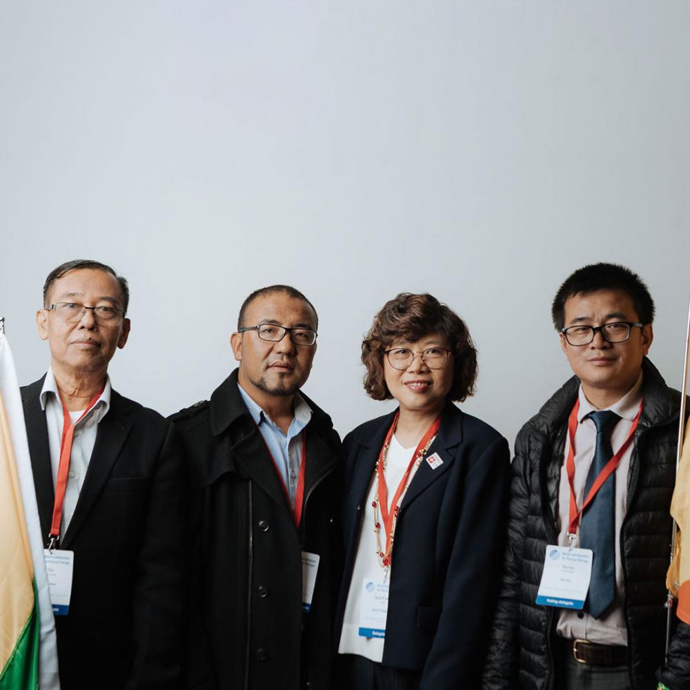 Four people standing in a row