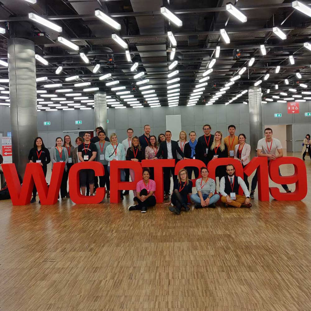 People crowd around large 3D letters spelling out WCPT2019