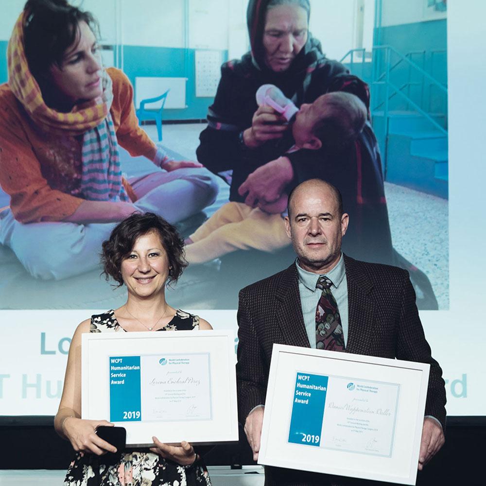 A woman and man holding their awards