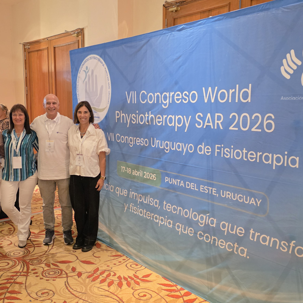 A group of professionals stood next to an event stand that is branded "afu"