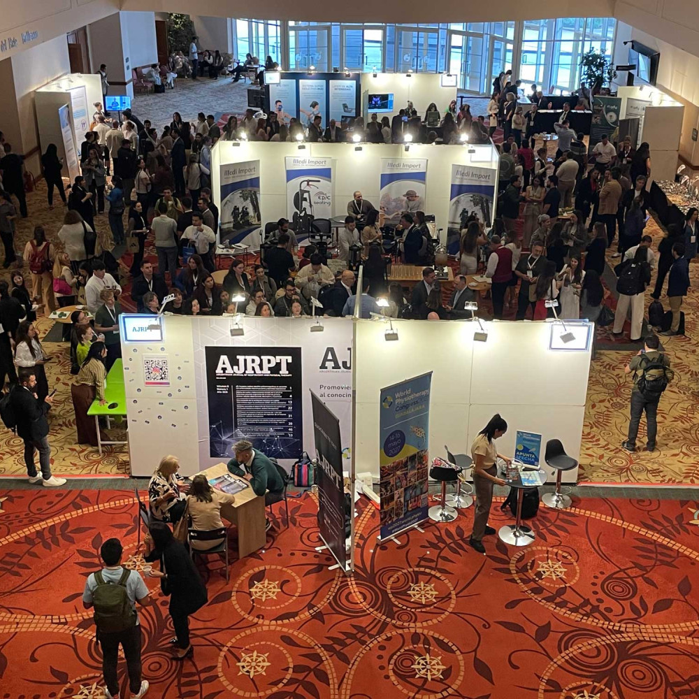 A large exhibition hall showing numerous stands and lots of delegates