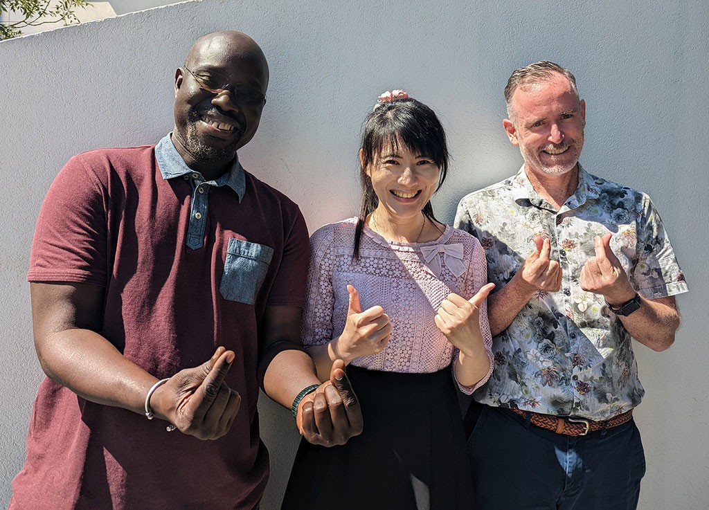 Pei-Yun Lee with Sidy Dieye, left, and Jonathon Kruger, right