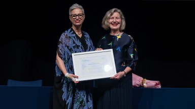 Margot Skinner receives Mildred Elson Award from Emma Stokes